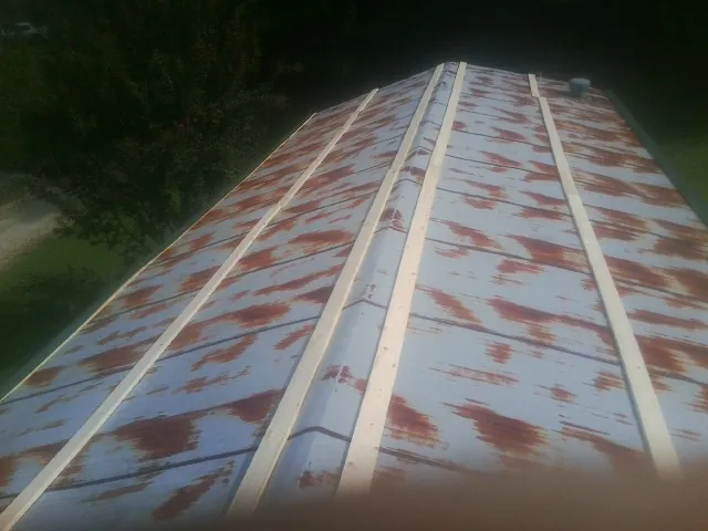 Rusted metal roof panels with new wood purlins before replacement — Storm Damage Roof Repair in Deer Island by Roofing Brothers